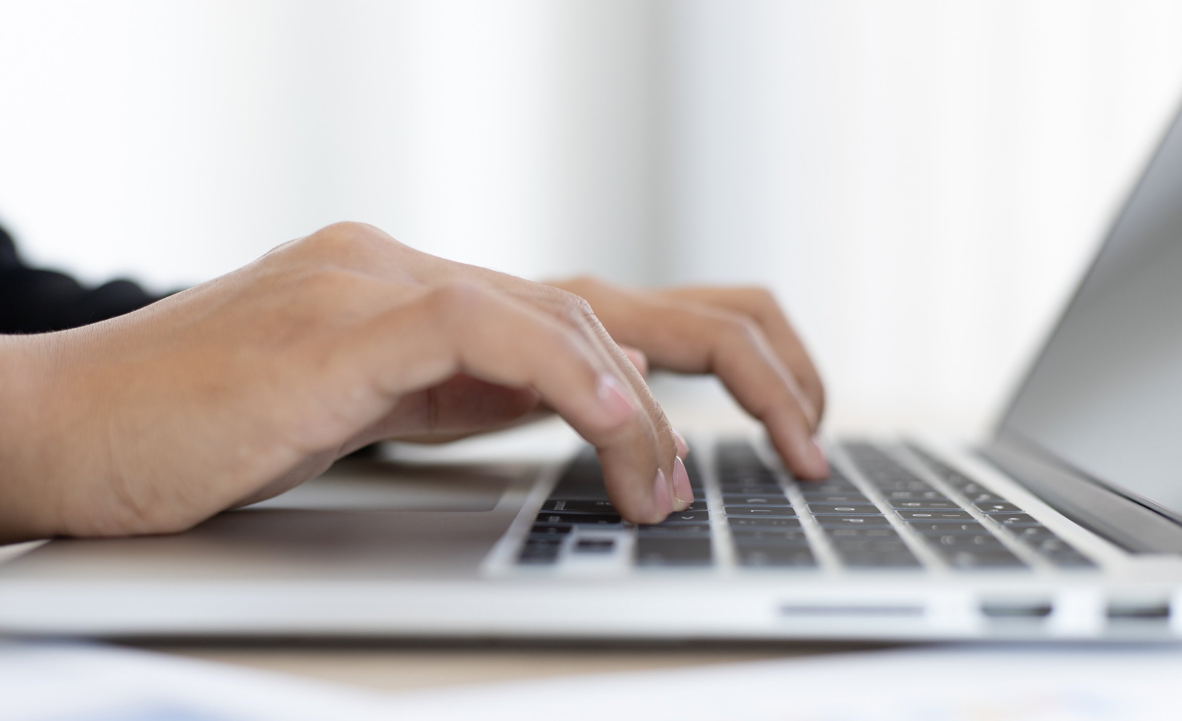 Close Up of Hands Typing on a Laptop 